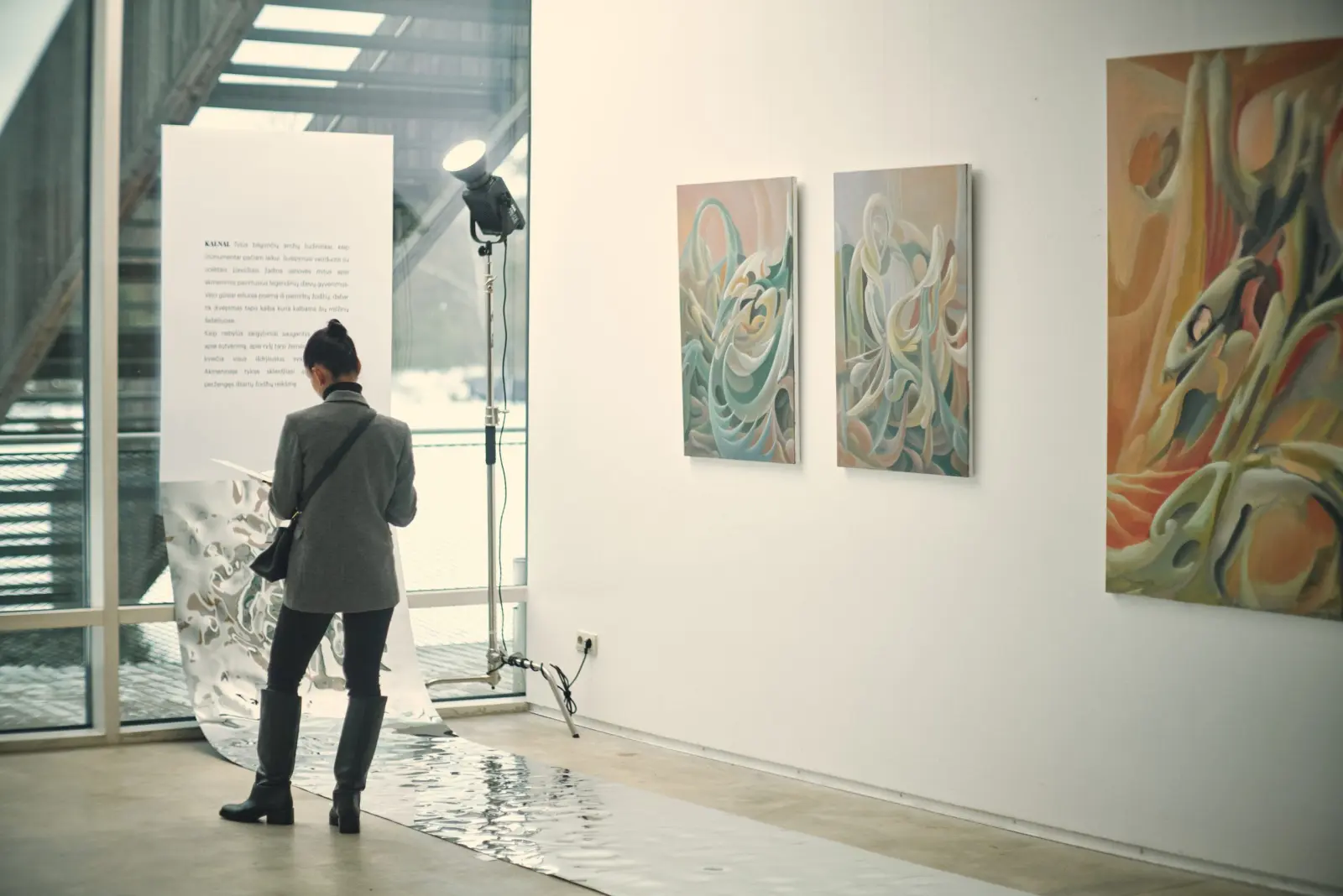 A visitor walking through the sunlit Dimension of the Heart exhibition