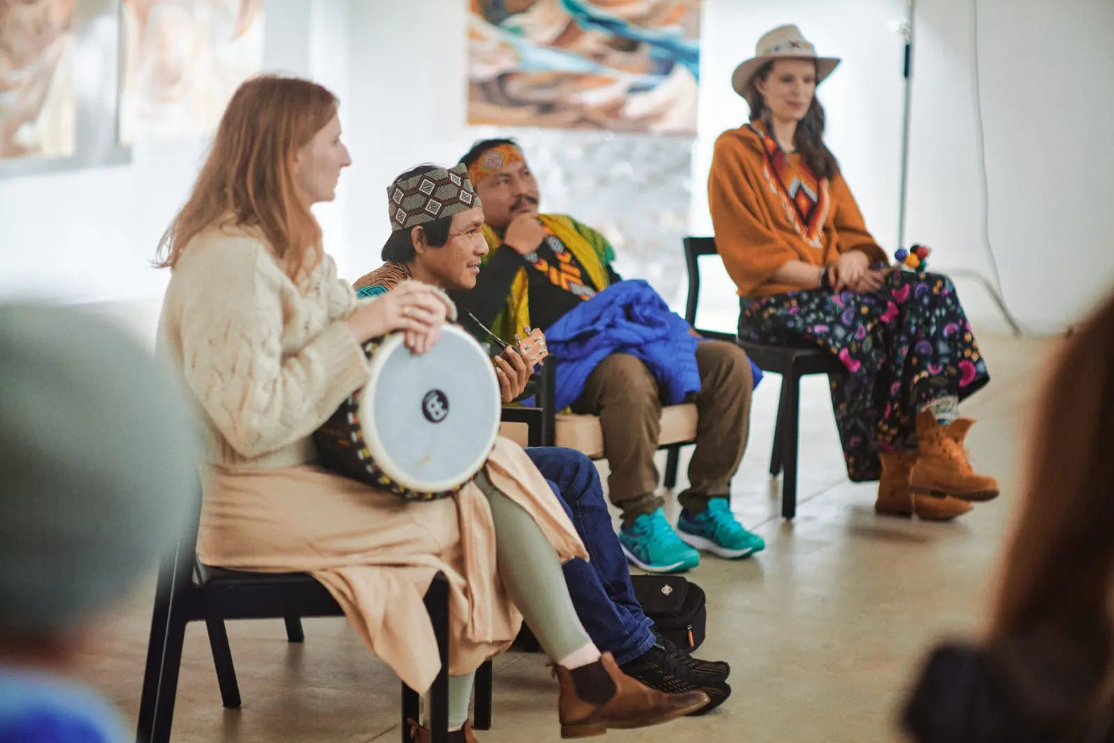 Seated participants with a hand drum at Dimension of the Heart