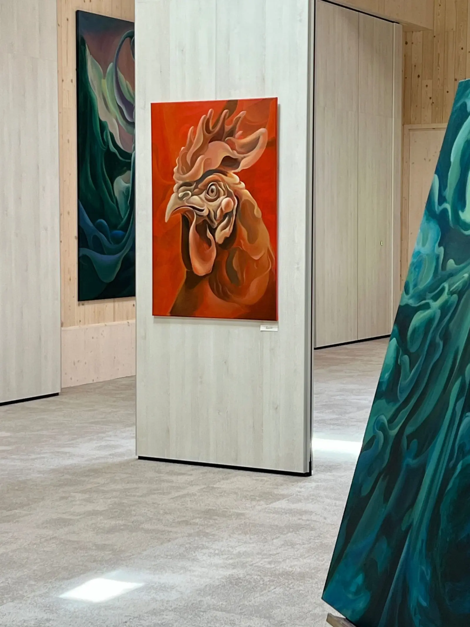 Paintings displayed between timber columns at the Nuoramos exhibition