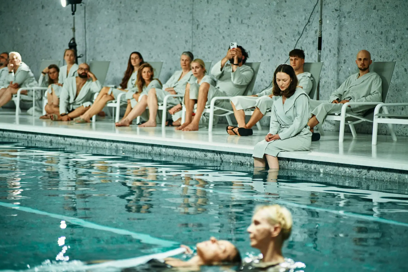 Audience watching the Water Body performance beside the pool