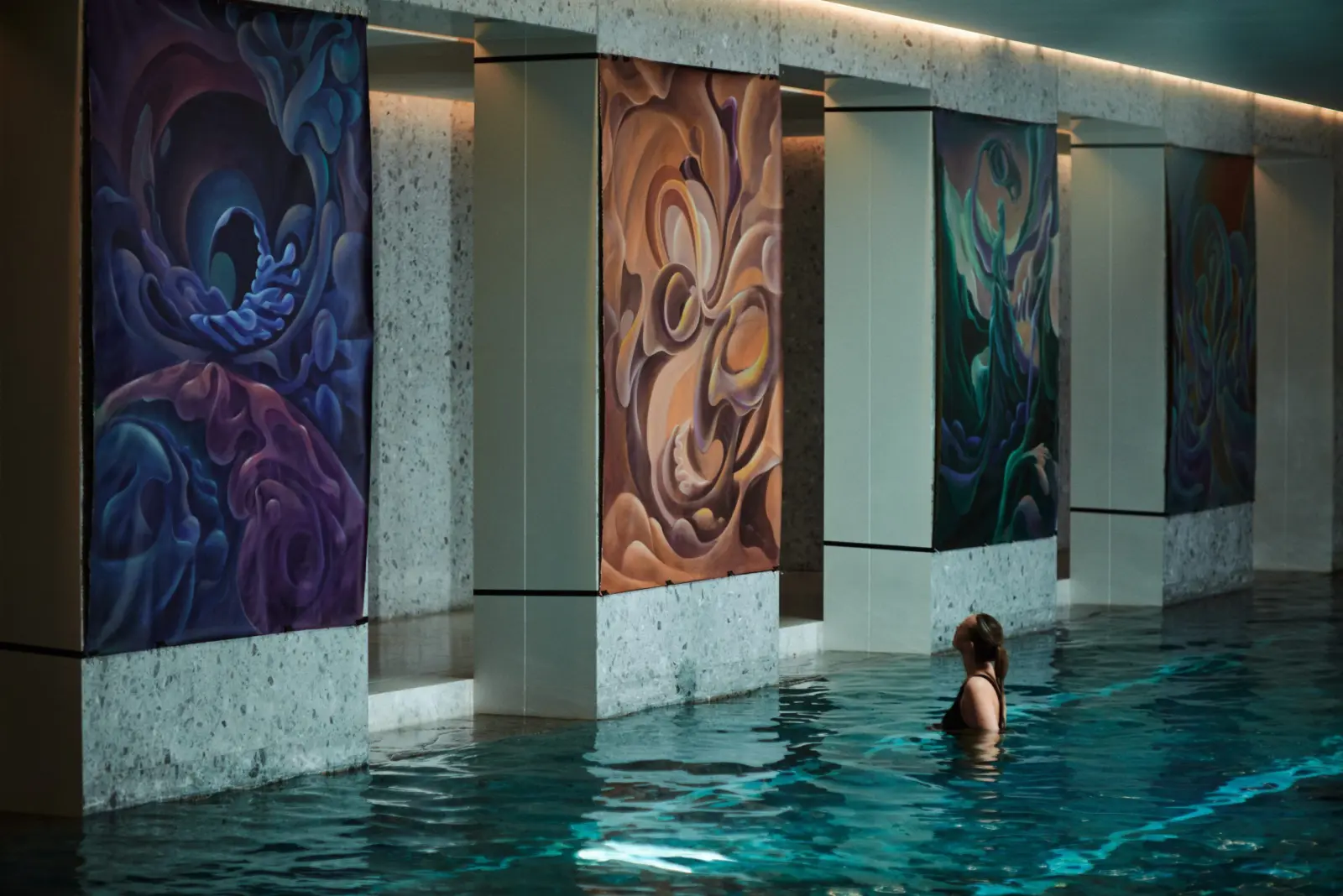 Paintings above the water during a pool session at Water Body
