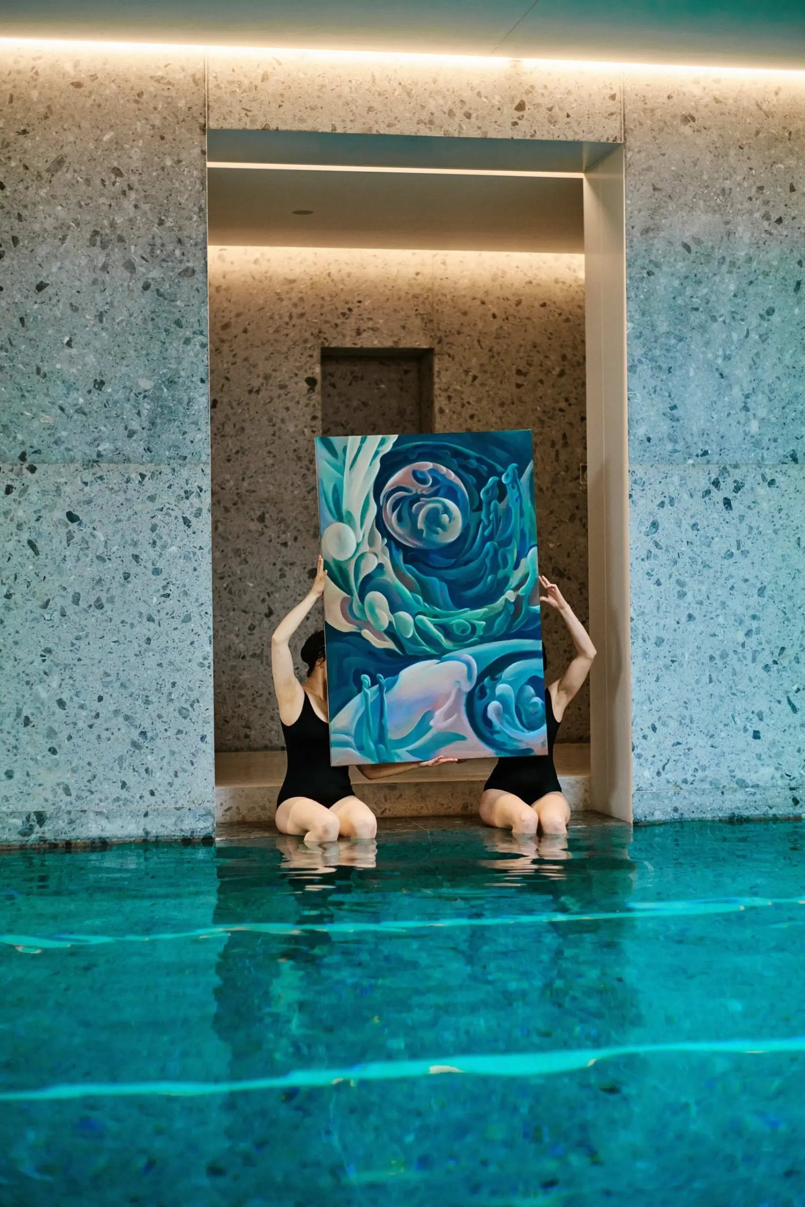 Water Body participants beneath a painting in an arched pool alcove